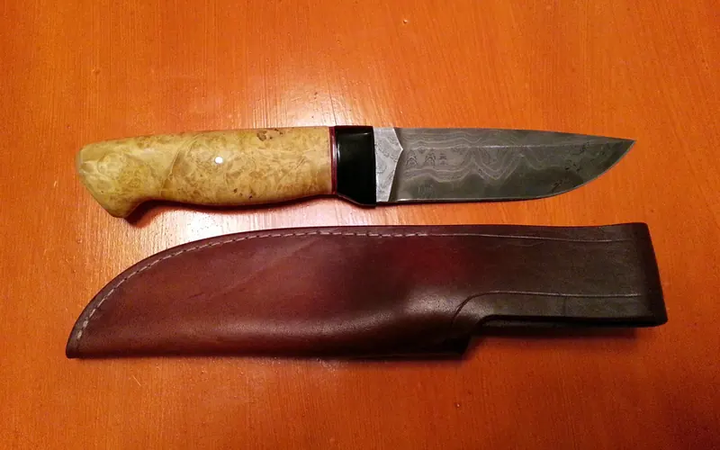 Laci’s knife and brown leather sheath lying side by side