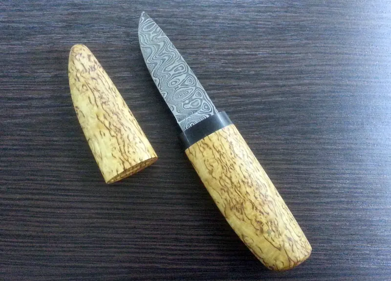 Small patterned-blade knife with a figured wooden handle and matching fitted wooden cover