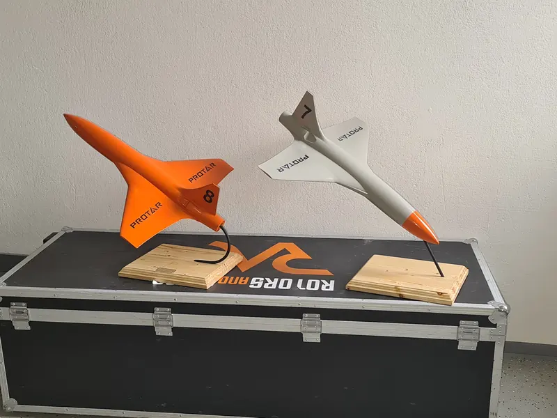 Orange and grey PROTAR aircraft display models mounted on wooden bases